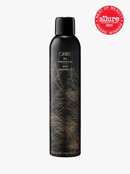 Oribe Dry Texturizing Spray black spray bottle with gold lines next to red BoB 2023 seal on light grey background